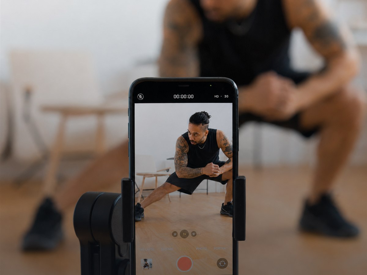 An athlete recording a training session on an iPhone